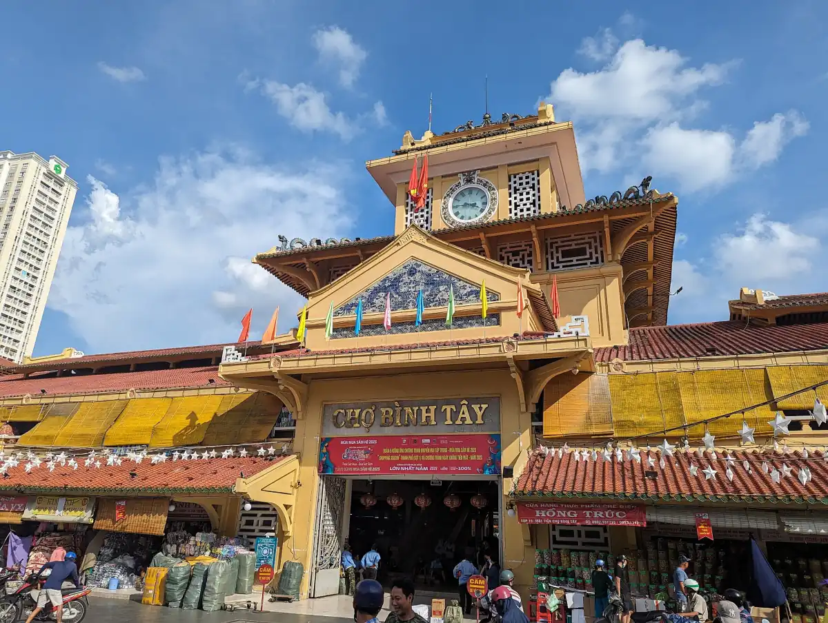 Eingang des Binh-Tay-Markts mit dem gestuften Turm unter blauem Himmel