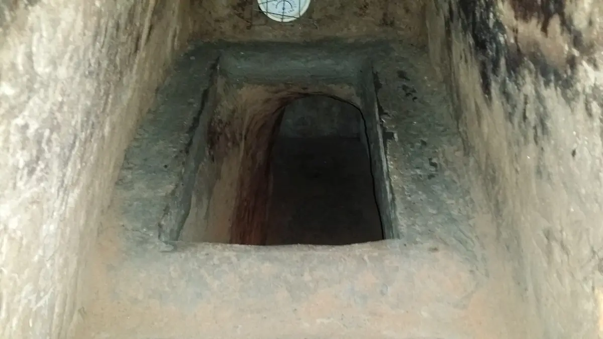 Widened tunnel entrance for visitors at the Cu Chi Tunnels
