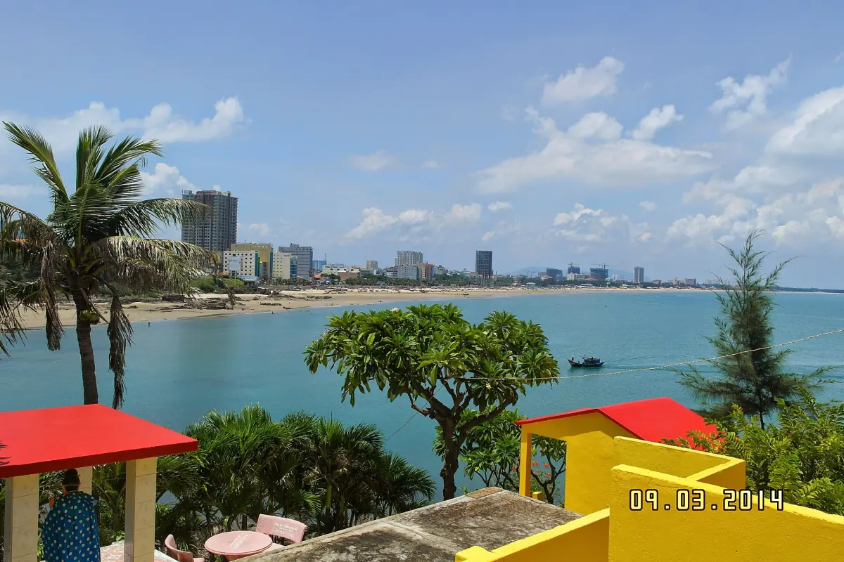 Palm trees and a curving bay with the Vung Tau coast beyond